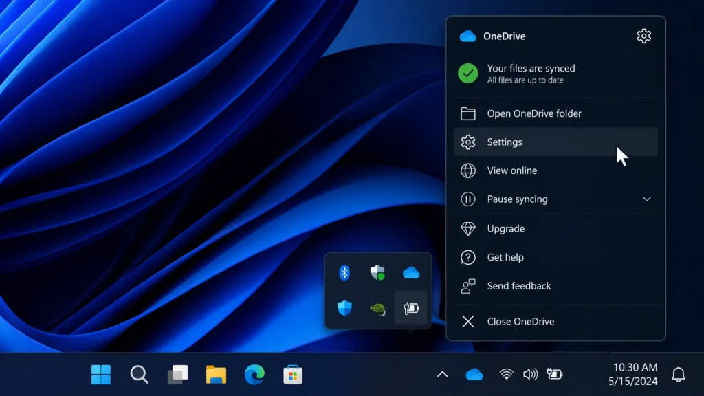 タスクバーの右端にある通知領域から青色または白色のOneDriveクラウドアイコンを左クリックして設定メニューを開く操作